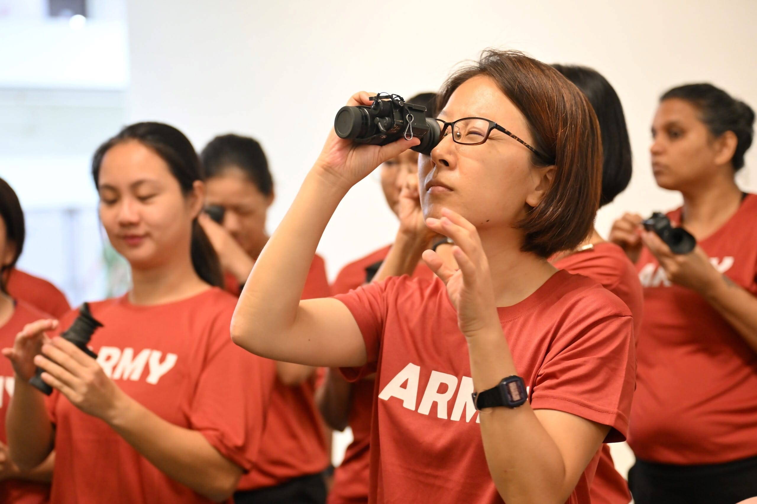 WBC25 participants having a hands-on experience with night vision equipment used in low light conditions.